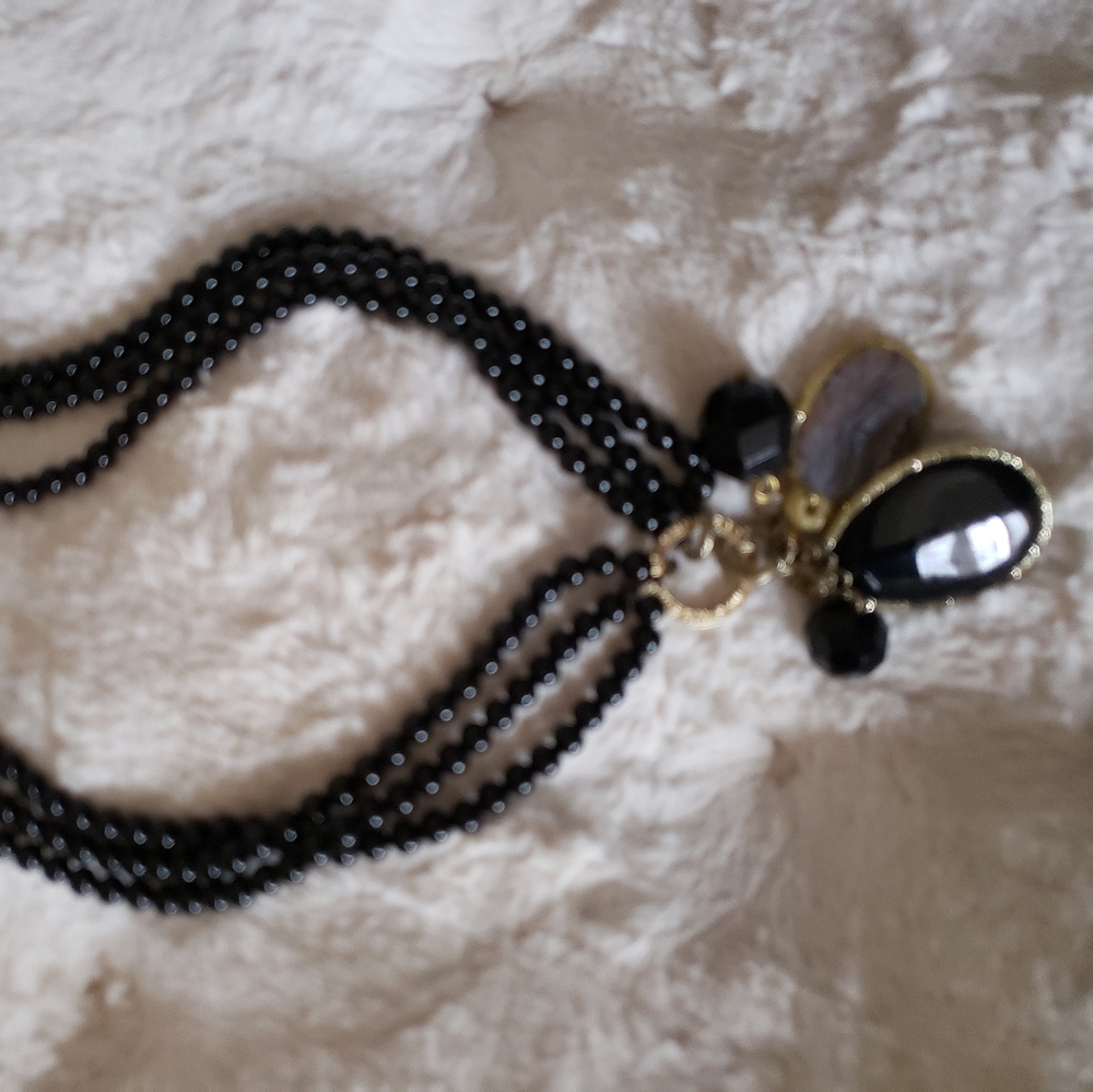 Real stones bunch necklace with black beads.